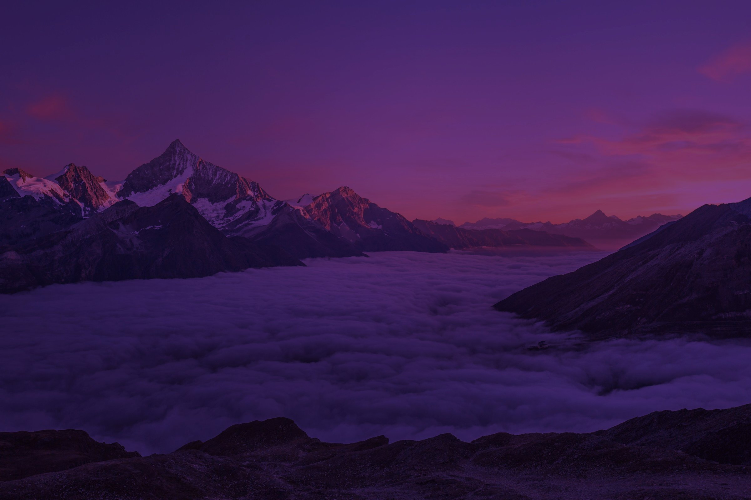 Mountain ridge above the clouds at dusk